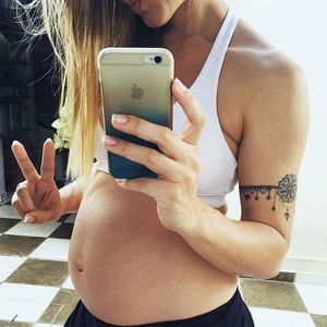 Pregnant young girl in a swimsuit gym