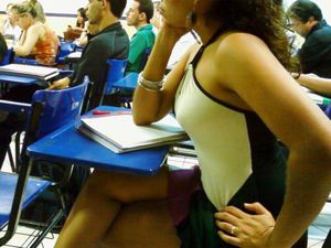 Adorable coed flashing pussy in class